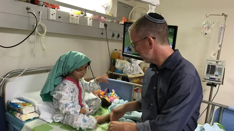 Dr. Morris Hartstein treating a Palestinian girl from Gaza with a lymphatic malf