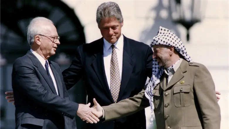 Arafat and Rabin shake hands after signing of Israeli-PLO peace accord