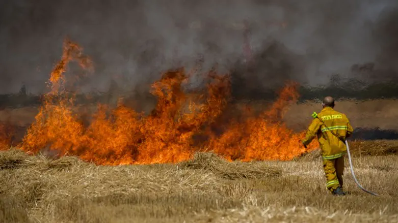 Firefighters work to put out kite fire near Gaza