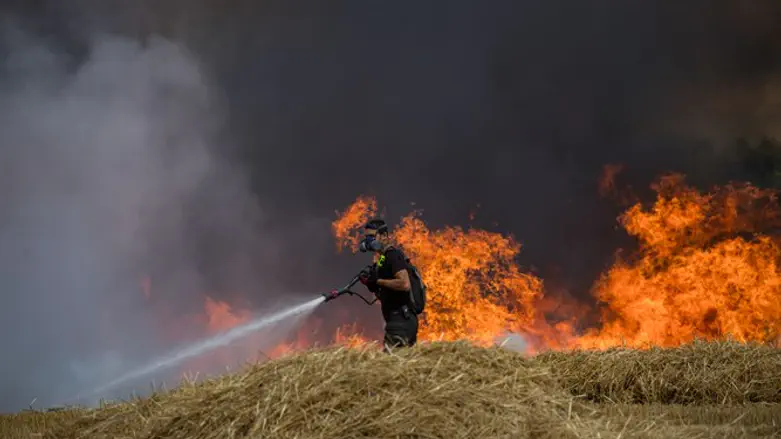 Firefighters extinguish fire in wheat field caused by Gaza incendiary kites