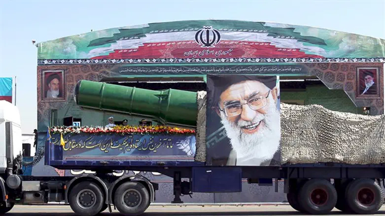 Iranian military truck carrying a missile and a picture of Iran's Supreme Leader Ayatoll