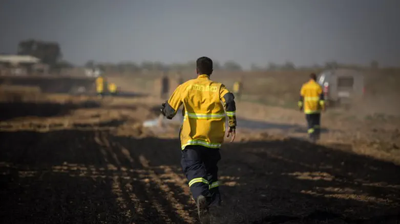 Firefighters run to extinguish Gaza area fire