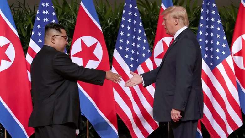 Kim Jong Un and Donald Trump shake hands