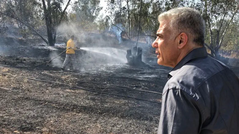 Lapid with firefighters in the Gaza Belt region