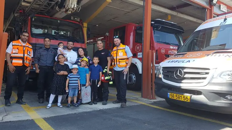 Hezki and his family with United Hatzalah volunteers at Rehovot's fire station