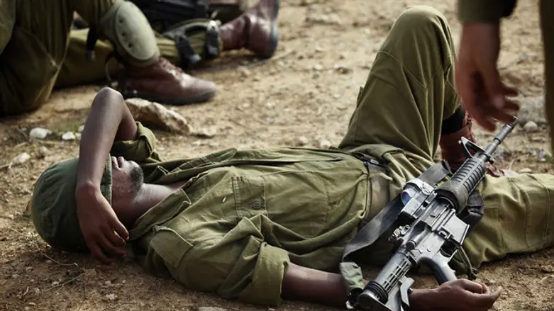 Soldier rests after grueling training at base near South Hevron Hill
