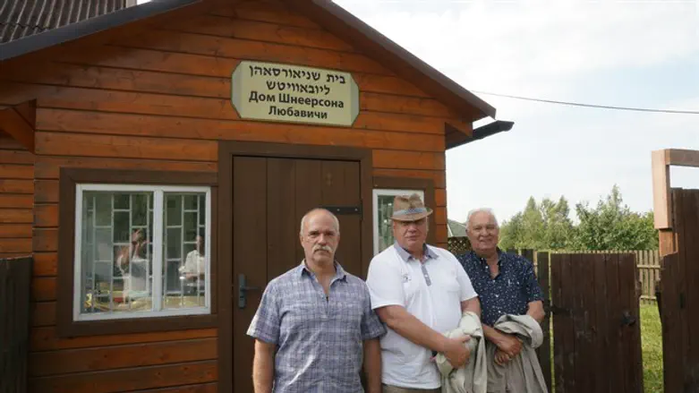 District Mayor Yuri Ivashkin, center, and his employees outside a Jewish cemetery