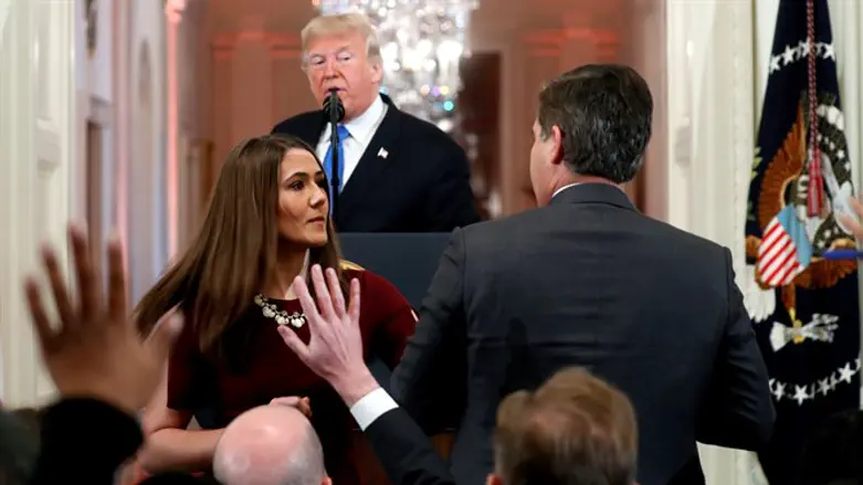 White House staff member steps in to try to take Acosta microphone