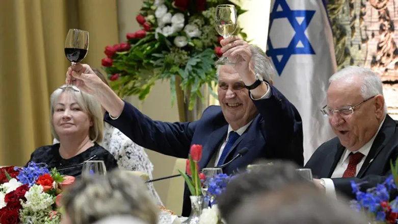 President Zeman raises two glasses in a toast
