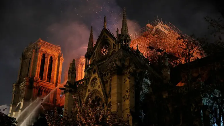 Paris Fire brigade spray water to extinguish flames as Notre Dame burns