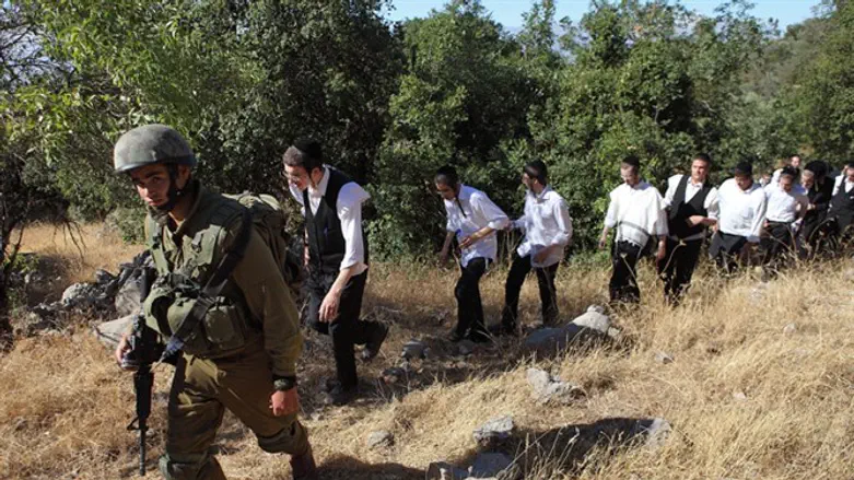 An Israeli soldier escorts ultra-Orthodox Jews 
