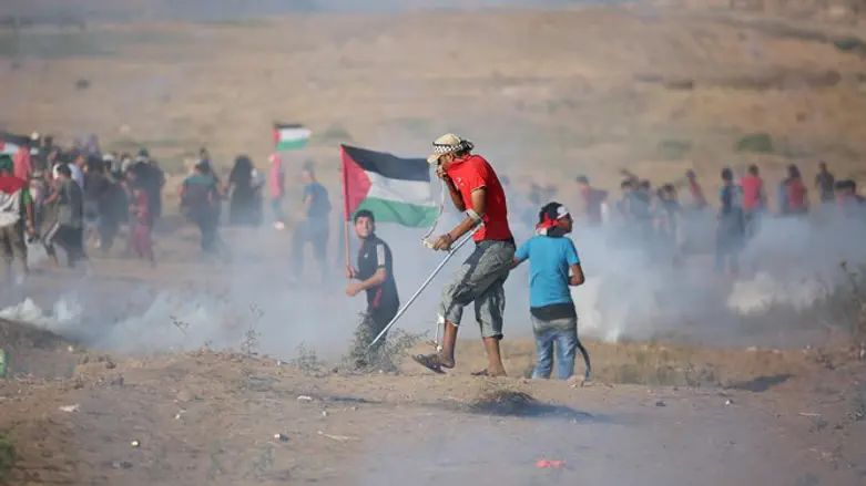 Protesters clash with Israeli forces at the Israel-Gaza border