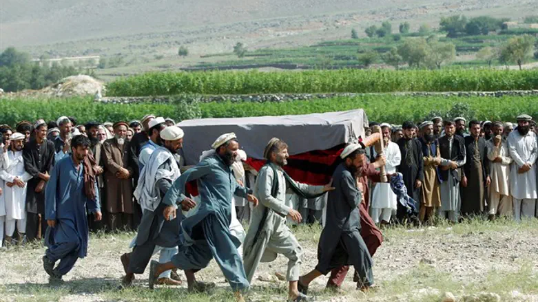 Afghani men carry coffin of victim killed in drone strike in Nangarhar province