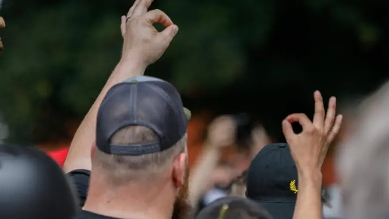 Members of 'Proud Boys' group make the "OK" gesture at a rally in Portland