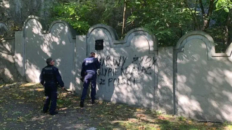 Swastika and other graffiti painted on wall of the former Krakow Ghetto