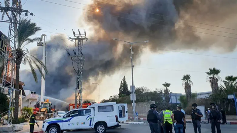 Israeli firefighters work to extinguish a fire at a factory in Sderot