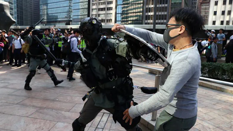 Anti-government protesters face off against riot police in Hong Kong