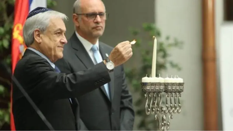 Chilean President Sebastian Pinera lights a Hanukkah candle