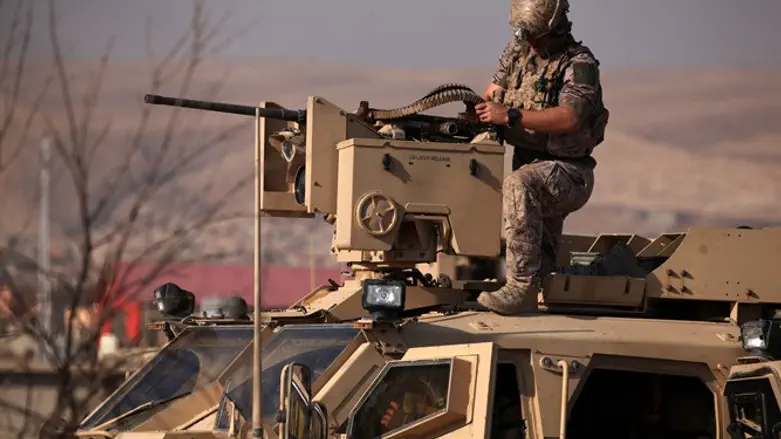American soldier on armored vehicle in Iraq