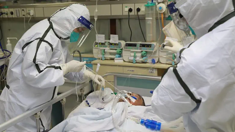 Medical staff in protective suits treat patient in Wuhan