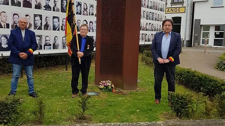 Michel Baert (R), and two commemoration activists laying a wreath at a Holocaust monument