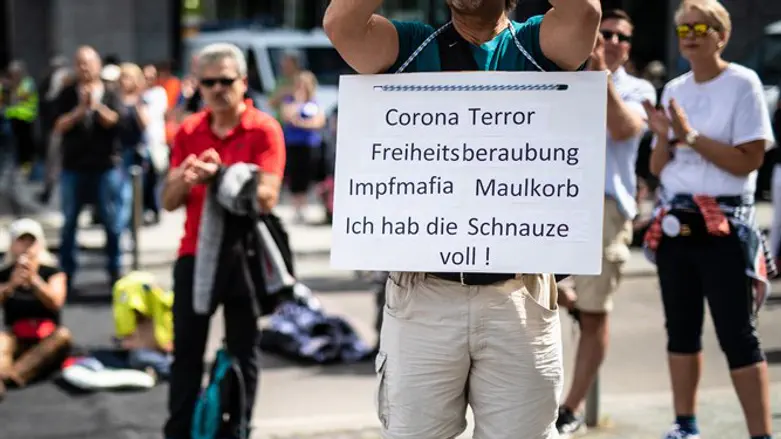 Protester holds ]sign in Stuttgart, Germany, reading: "Corona Terror - Deprivati