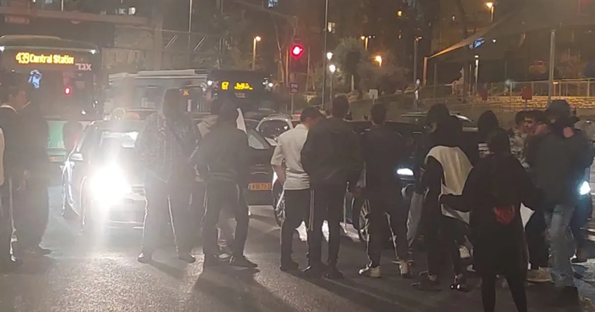 Dozens protest near scene of Jerusalem bombing, blocking
road