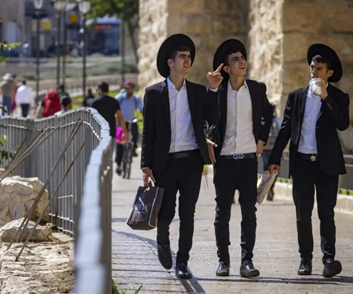 Hared Jewish men walk near the Jaffa Gate in the Old City of Jerusalem,