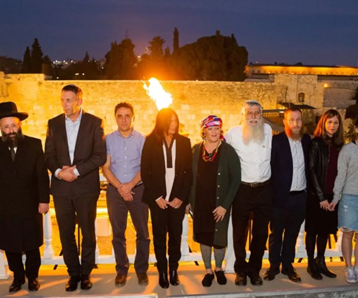 Family of Eli Kay at Hanukkah lighting candle