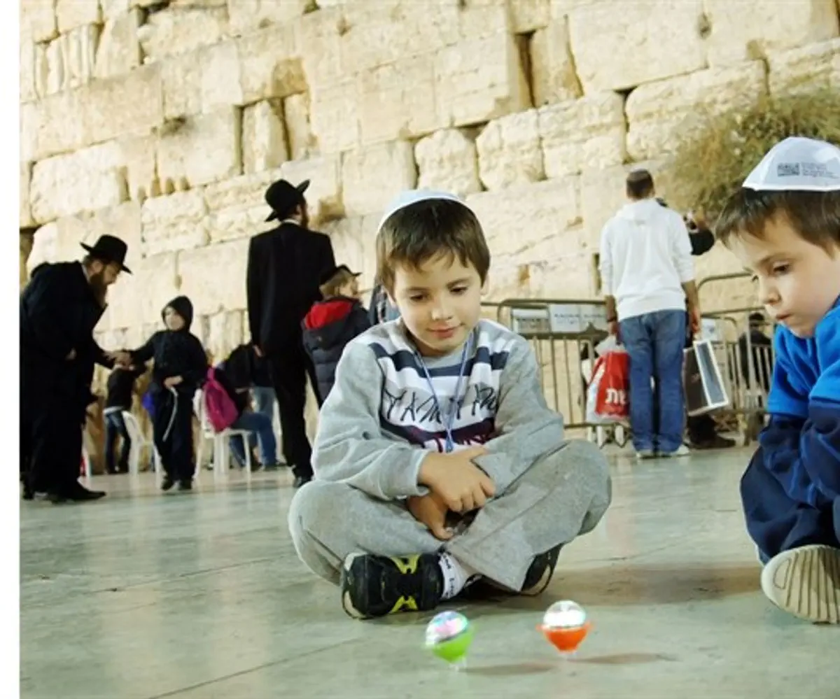 Playing with dreidels at the Western Wall, Hannukah