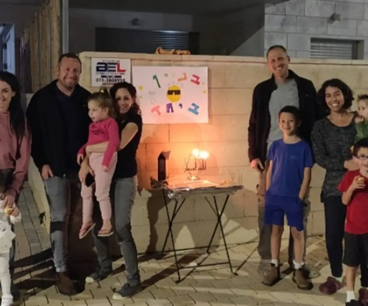 Lighting the Hanukkah menorah with neighbors