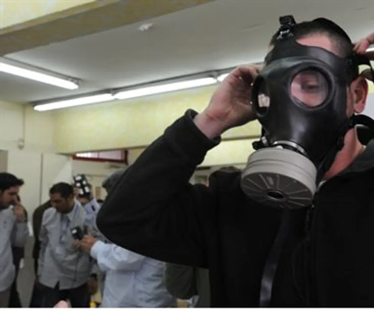 Man tries on gas mask