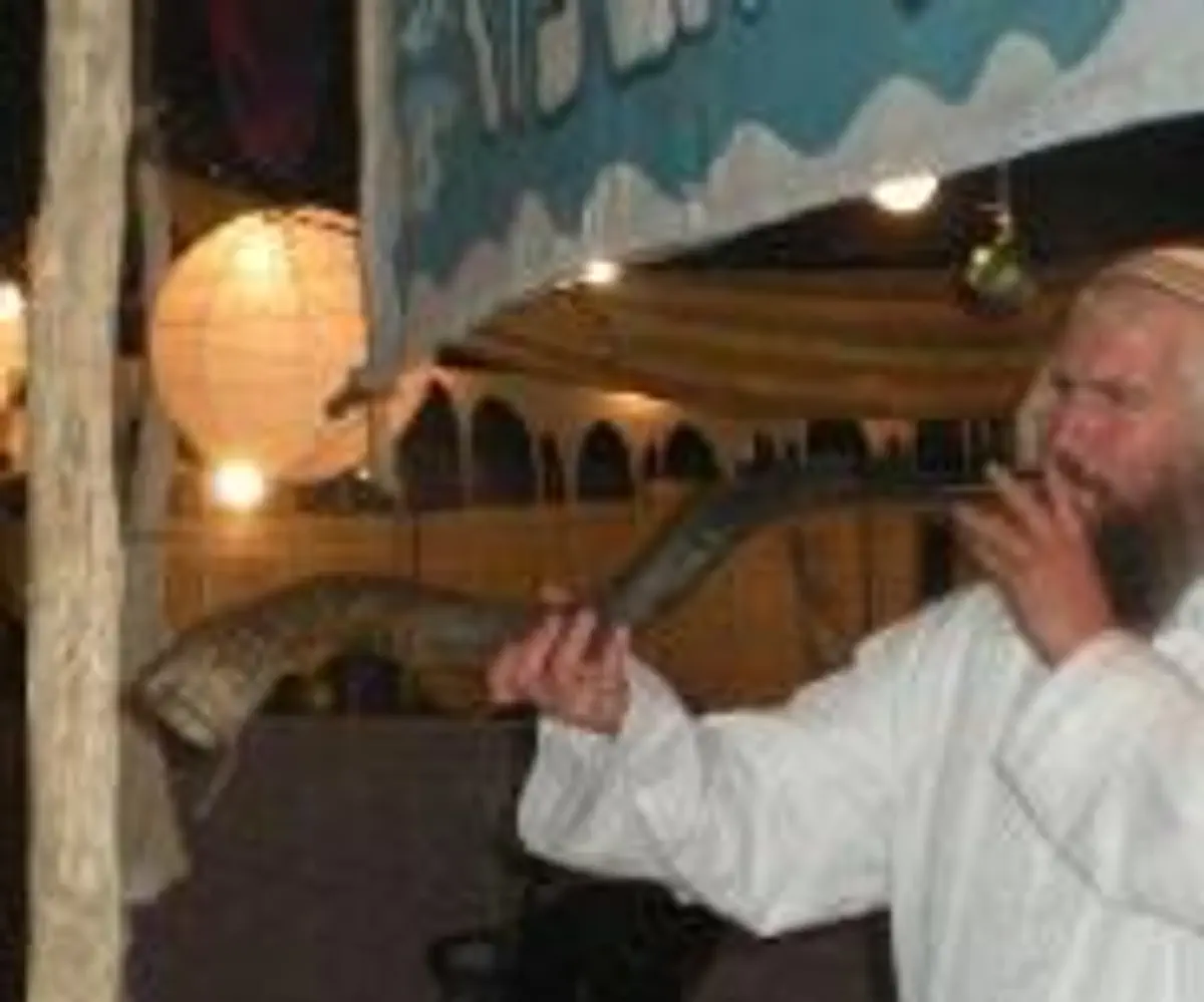 blowing shofar at "Kfar Tefillah" tent