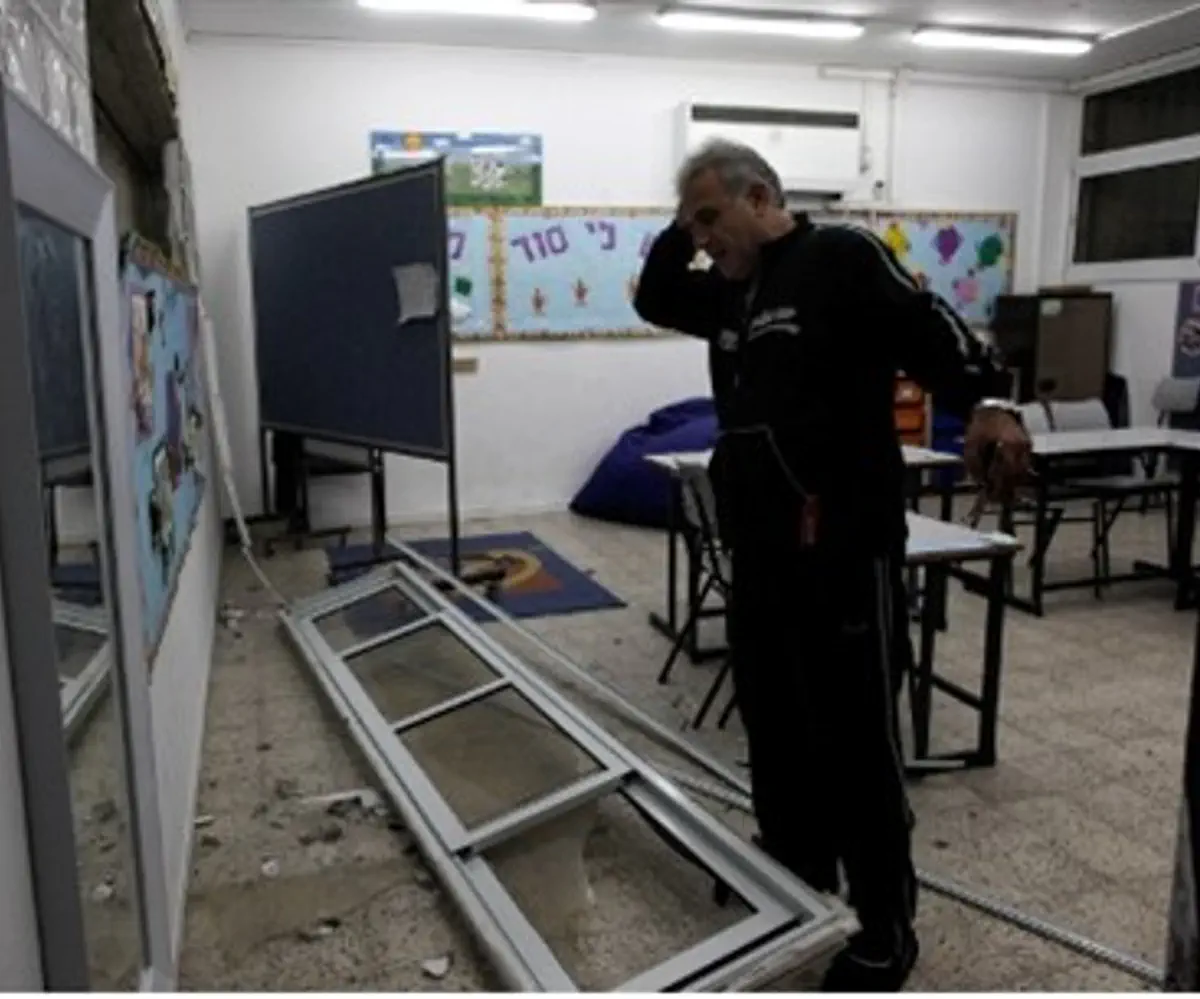 Man surveys rocket damage at Ashdod school
