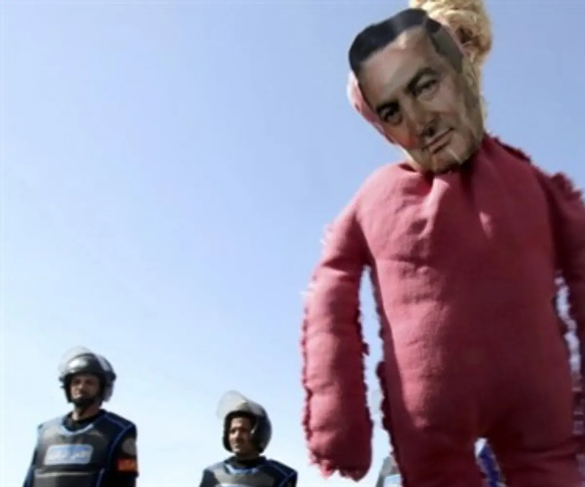A protesters' effigy of Hosni Mubarak hangs o