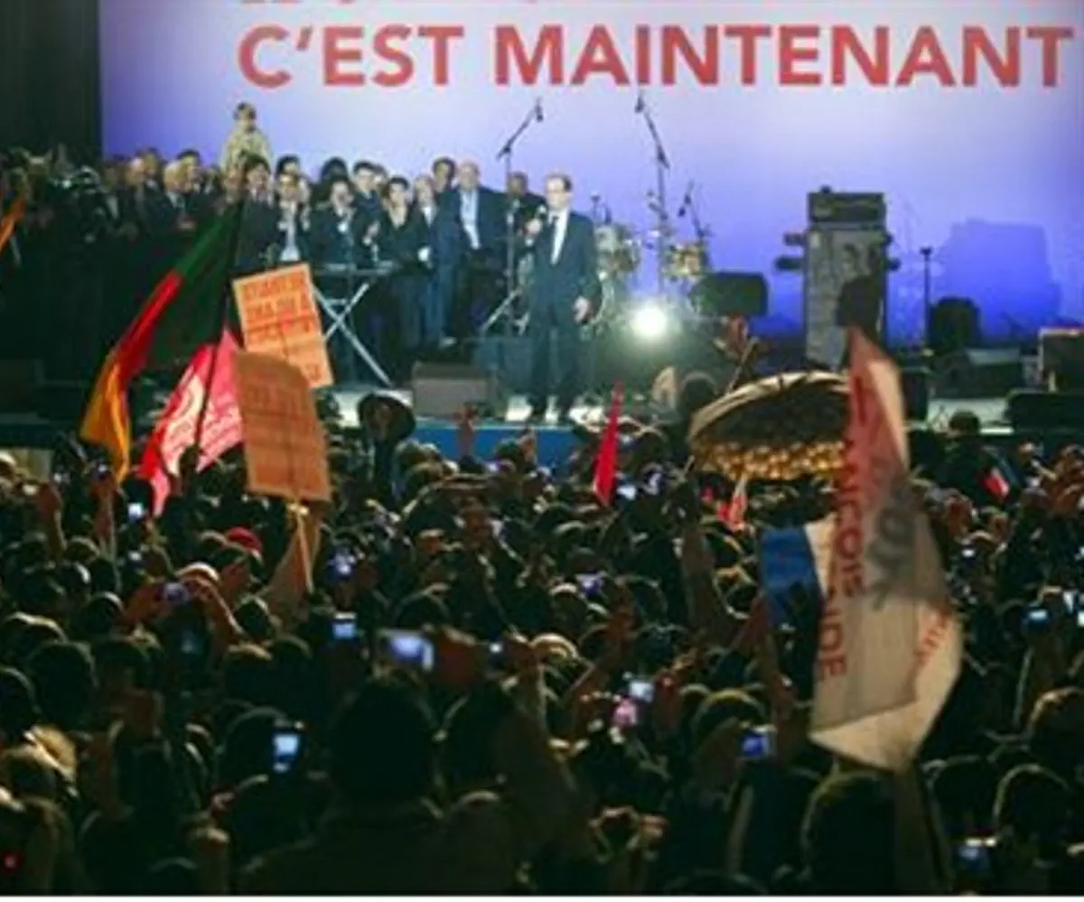 Celebrants at Hollande victory rally wave for
