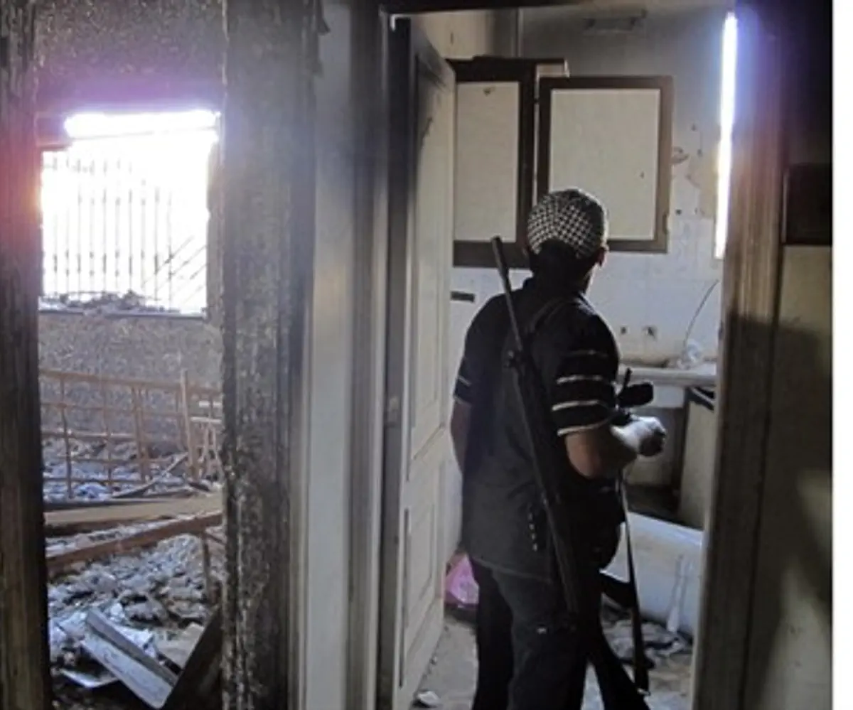 FSA soldier checks building in Aleppo provinc