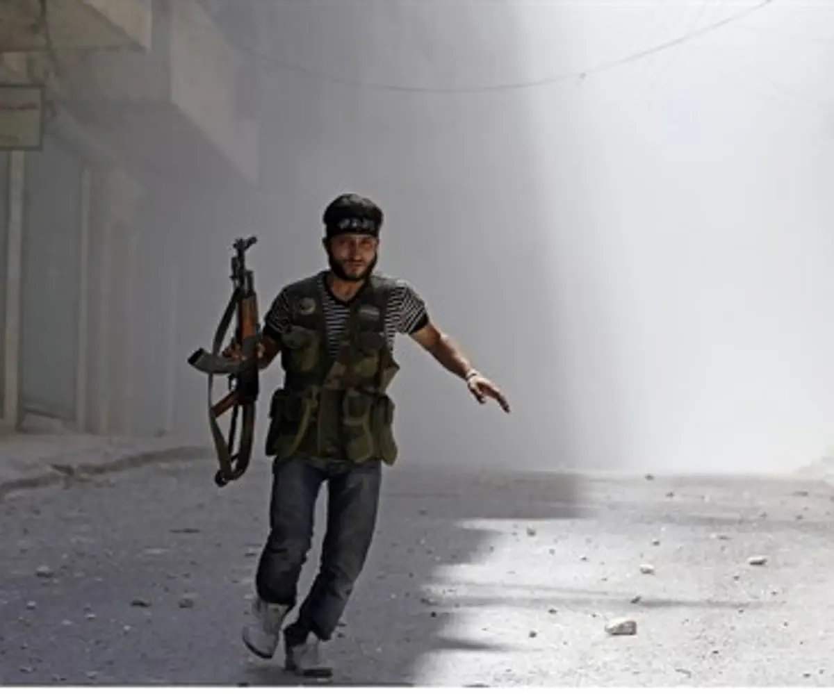 A Free Syrian Army fighter runs in Aleppo
