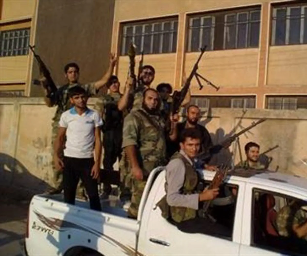 Free Syrian Army fighters pose with their wea