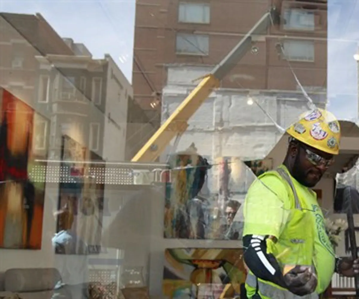 Construction workers clean up an art gallery 