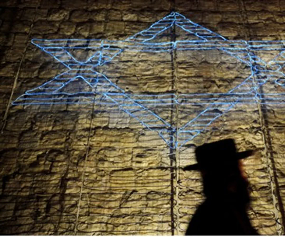 Jewish man walks by Star of David