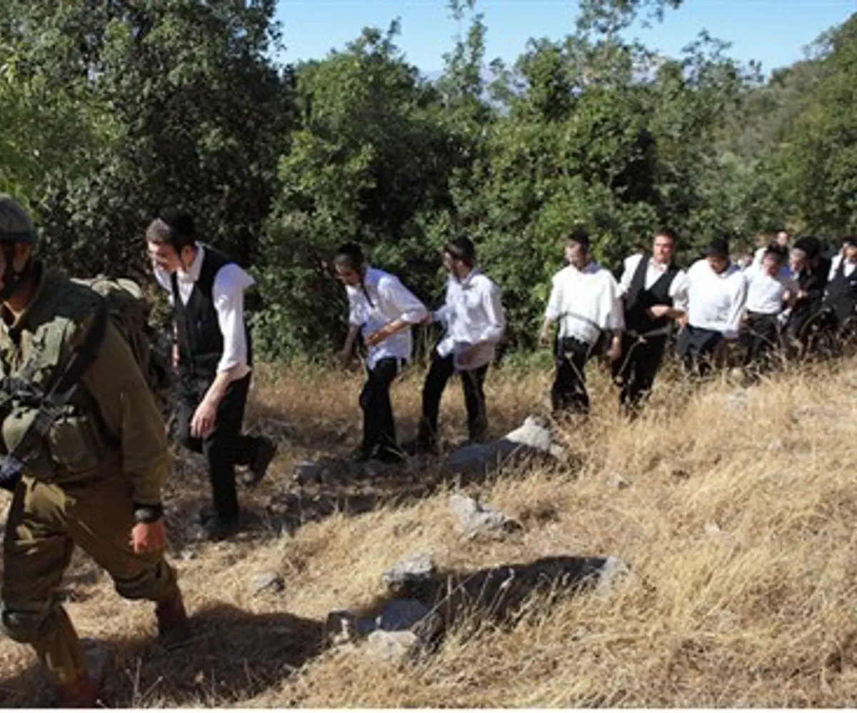 An Israeli soldier escorts ultra-Orthodox Jew