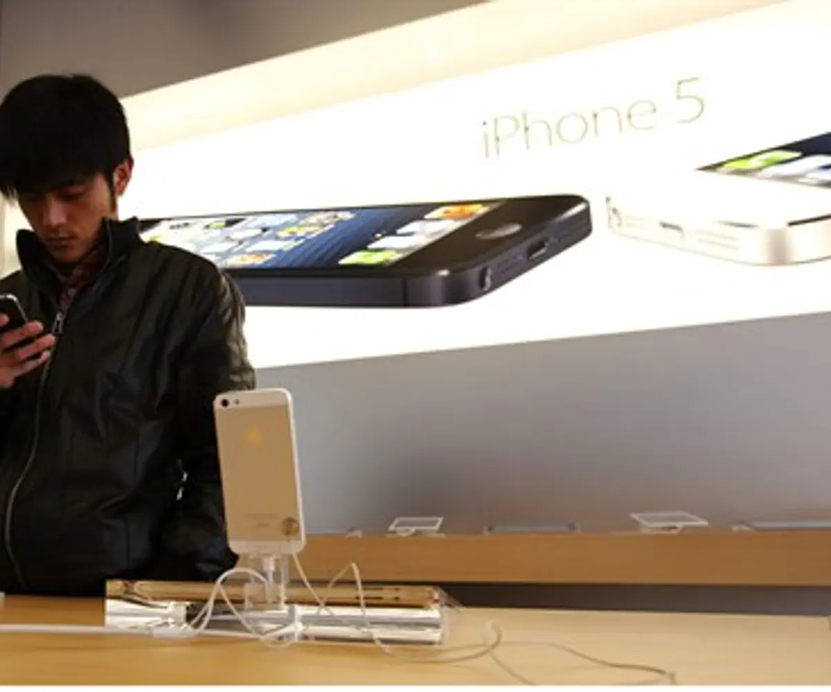 A visitor tries an iPhone at an Apple store 