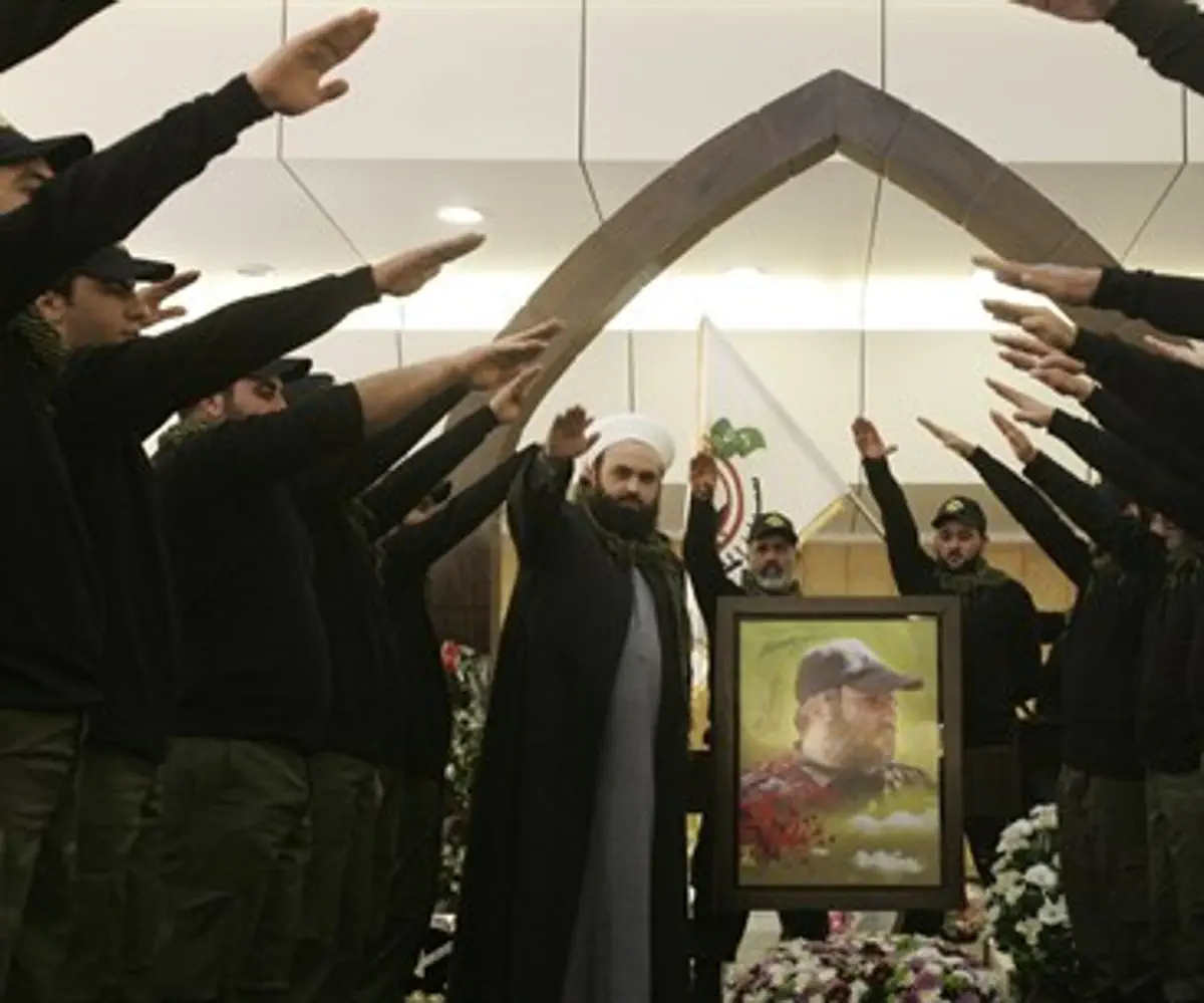 Islamist Hezbollah supporters salute at memor