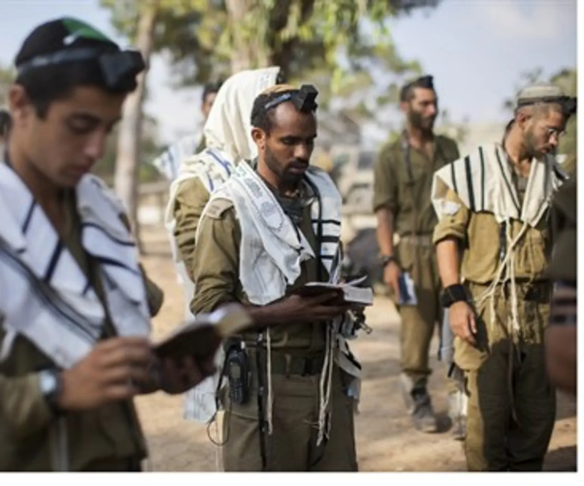 IDF soldiers pray near Gaza