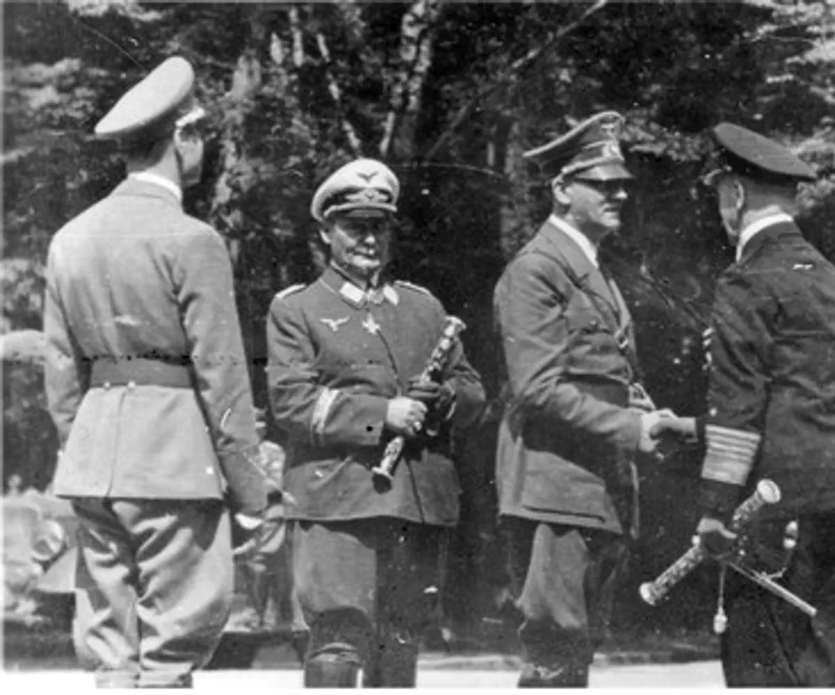 Hermann Goering (2nd L) with Adolf Hitler (C)