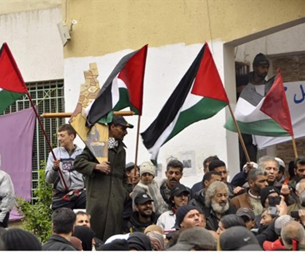 Residents of Yarmouk wave PLO flags