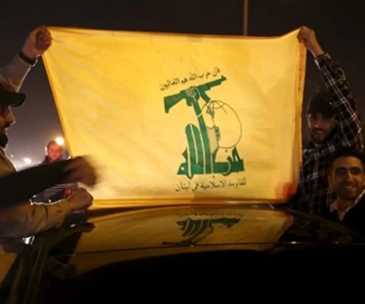 Hezbollah supporters hold a Hezbollah flag