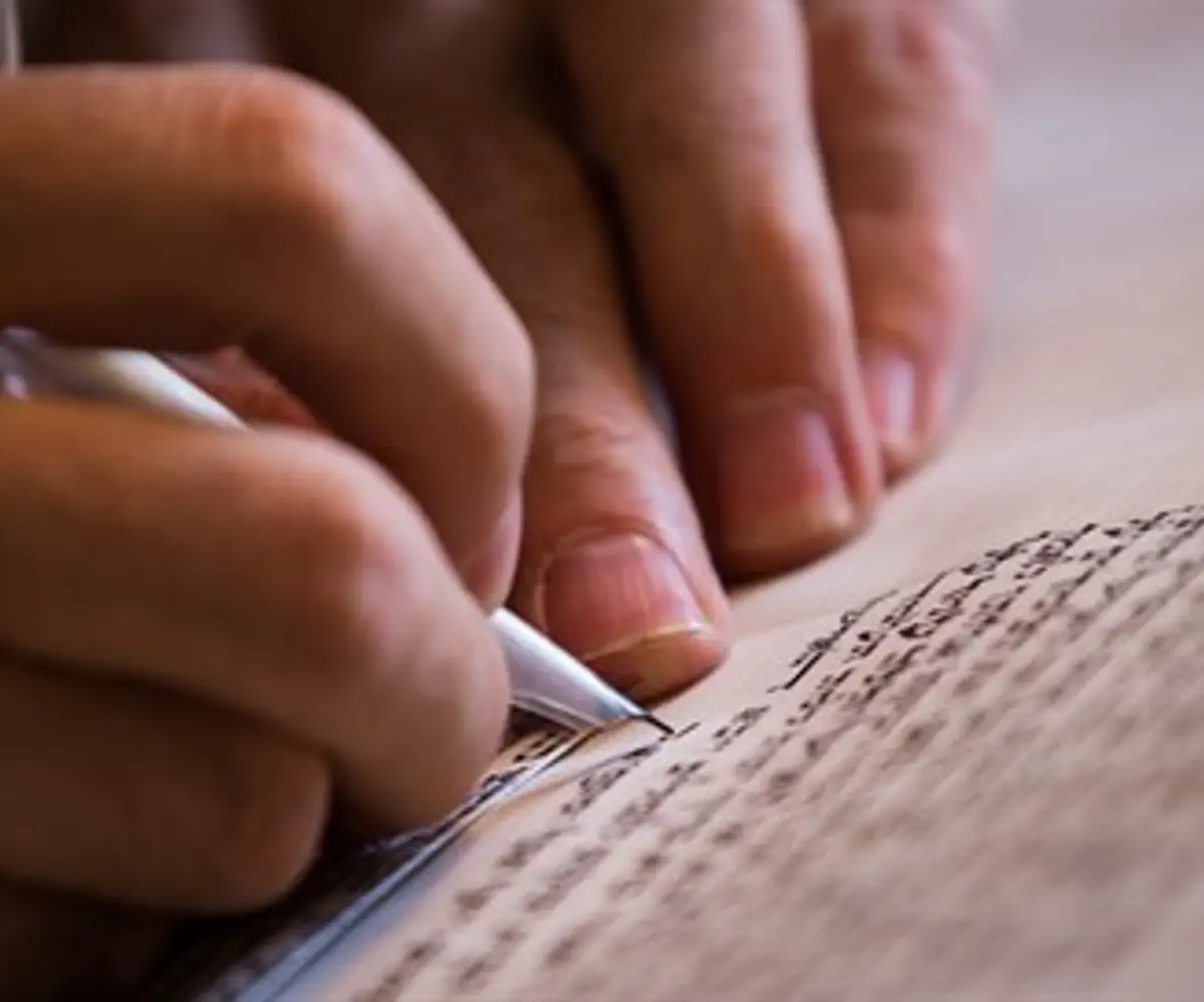 Scribe writes a Torah scroll (illustration)