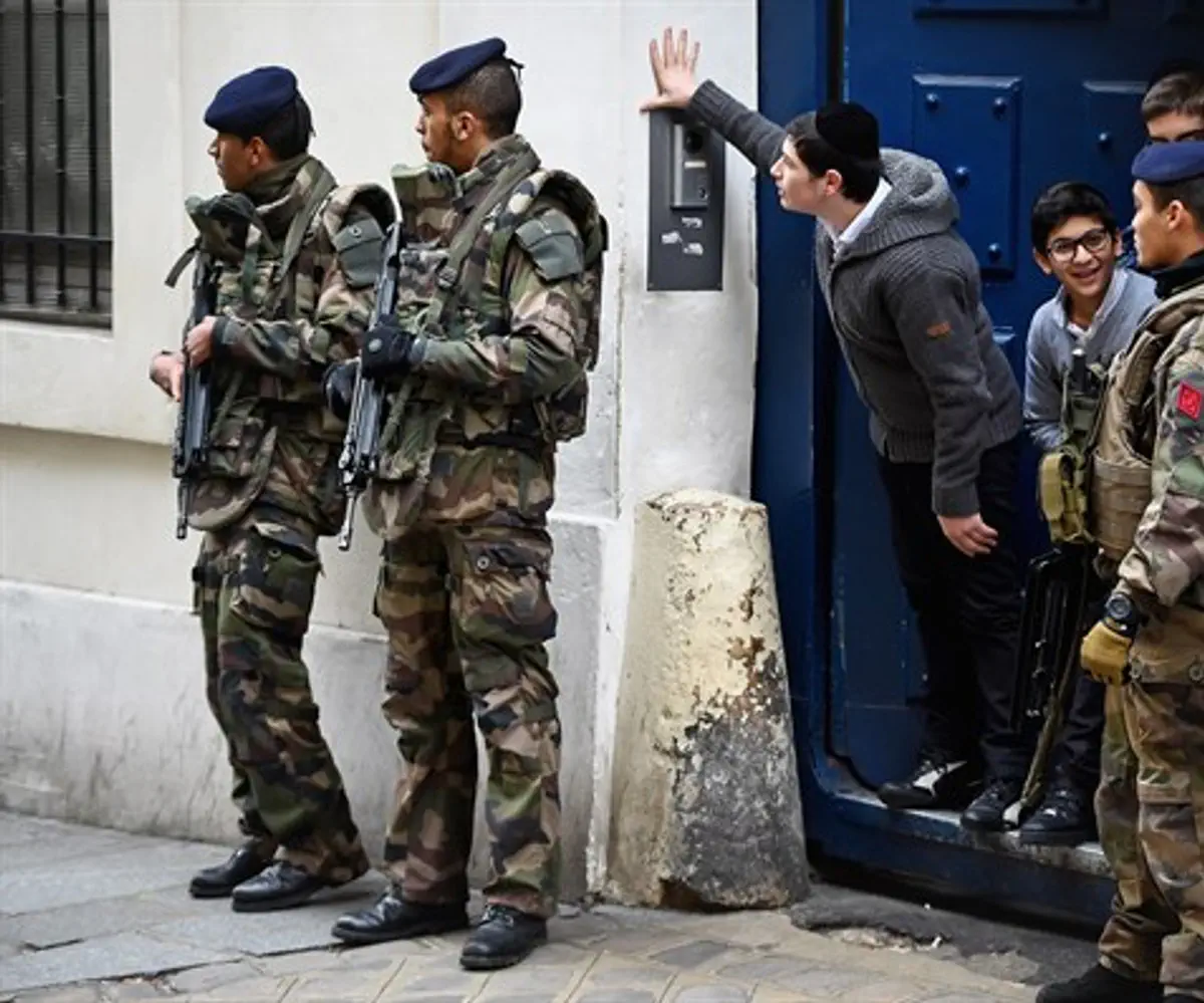 Armed soldiers patrol outside school in the Jewish quarter of the Marais district in Paris